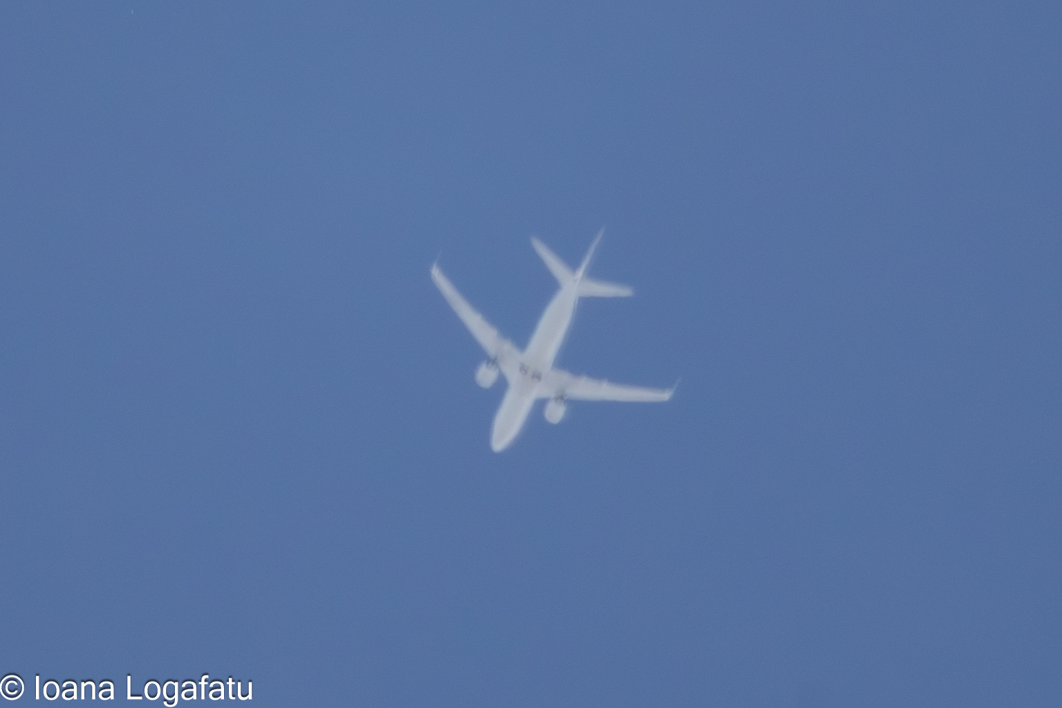 Airplane soaring high against a clear sky